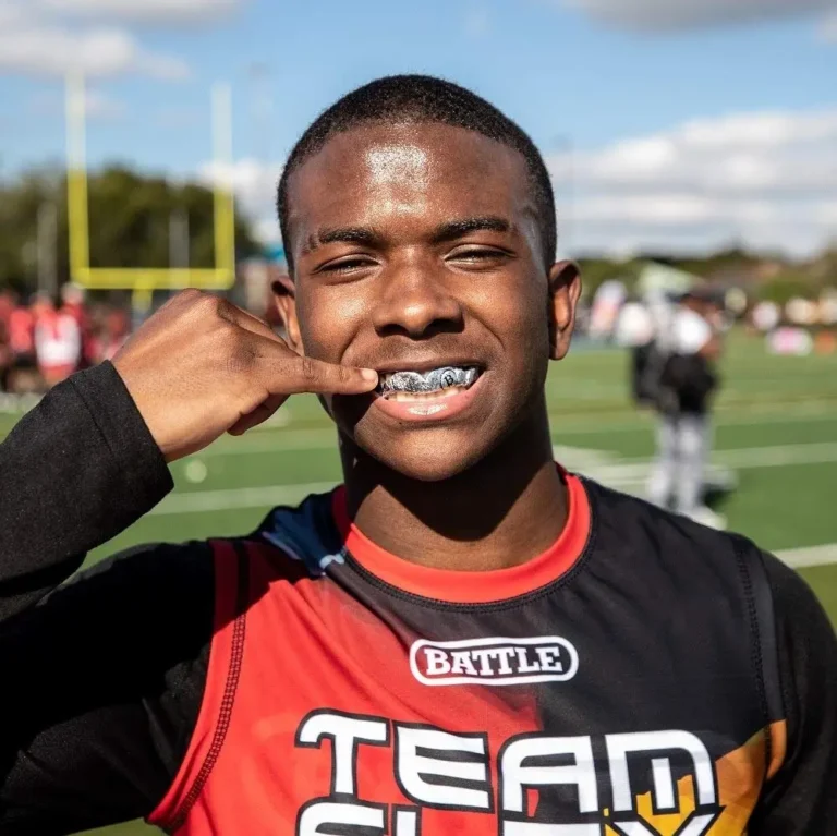 Can you wear grillz while playing sports? Gold grillz beside a sports mouthguard